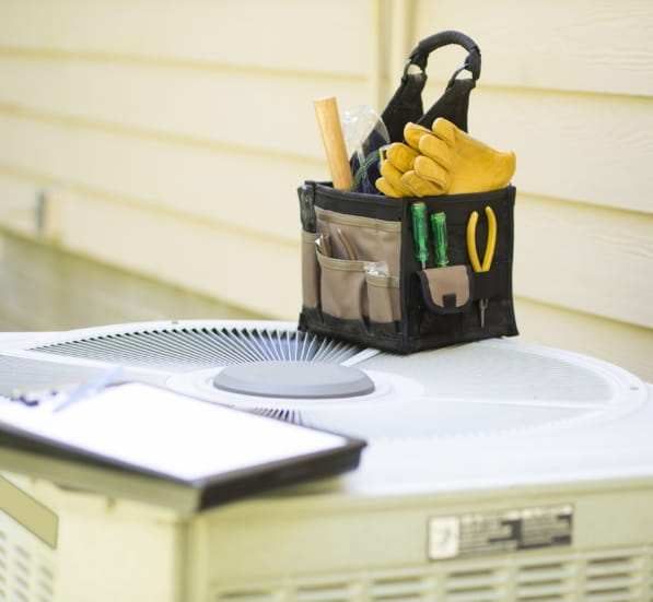 gloves on the top of an HVAC system 